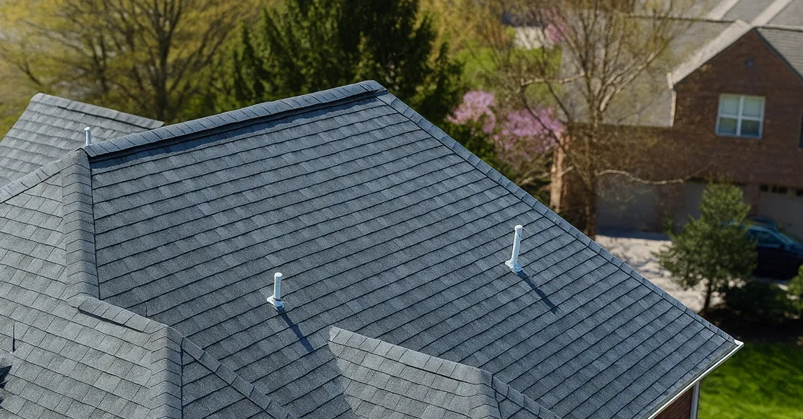 Philadelphia roofing expert demonstrating roof capping benefits on a residential roof ridge